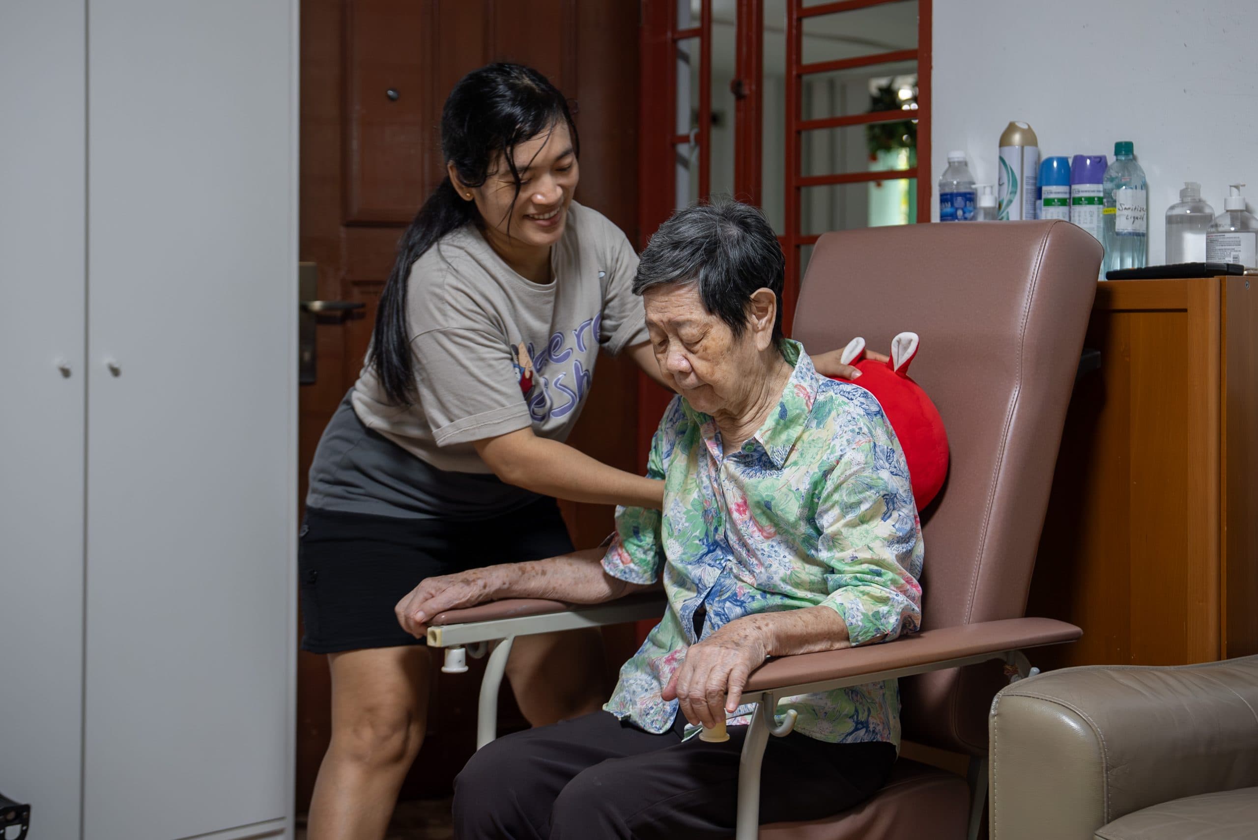 A caregiver and elderly resident sharing a moment at home